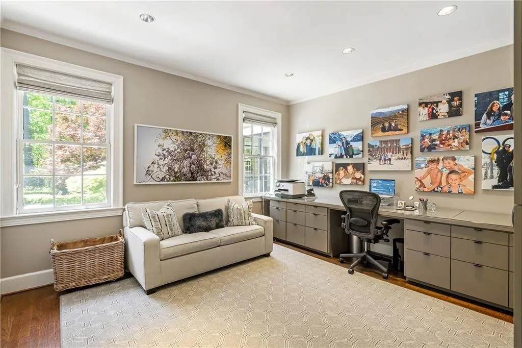 Office space with plenty of natural light, light wood-style floors, ornamental molding, recessed lighting, and baseboards