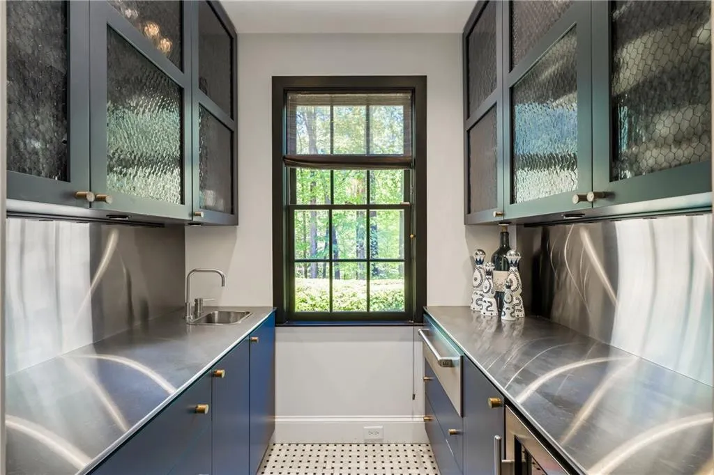 Bar with a sink, baseboards, healthy amount of natural light, and tile patterned floors