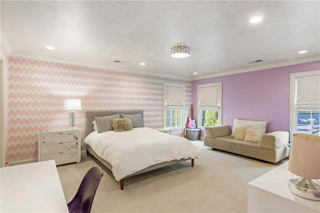 Bedroom with recessed lighting, light carpet, crown molding, and wallpapered walls