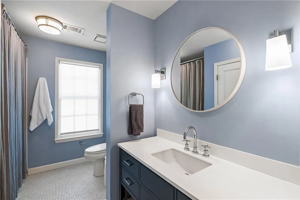 Bathroom with baseboards, toilet, vanity, and tile patterned floors