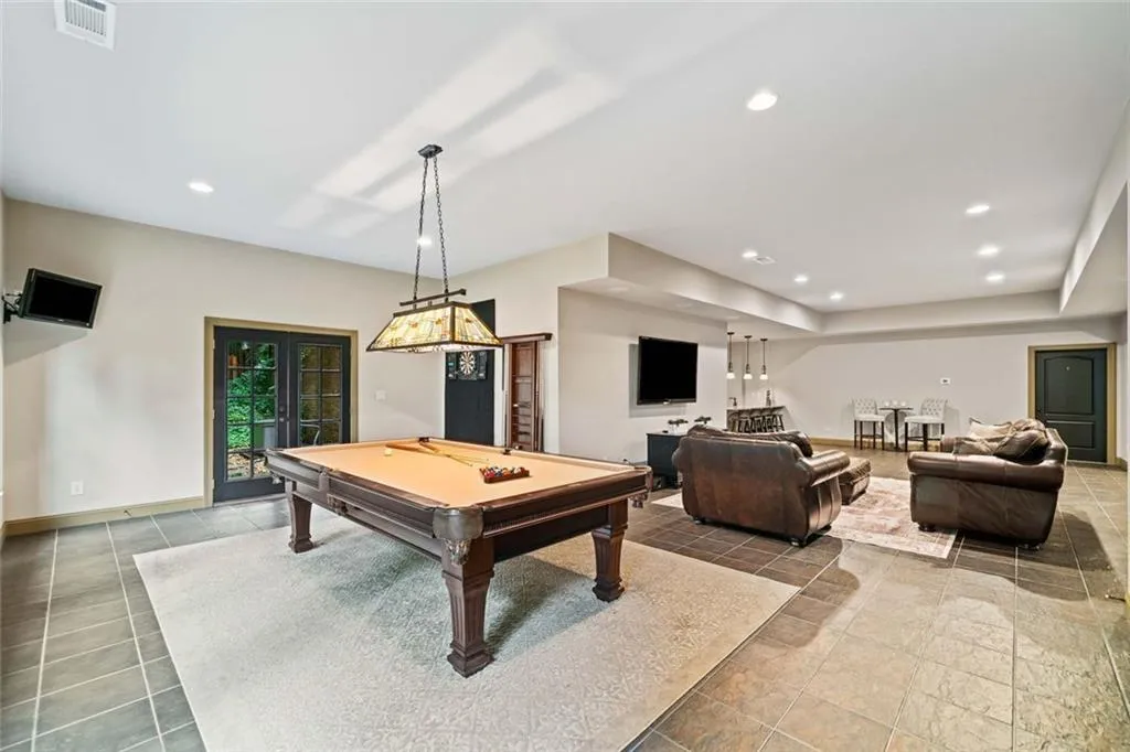The central entertainment area is ideal for a billiard table and darts plus wall mounts ready for multiple TVs.