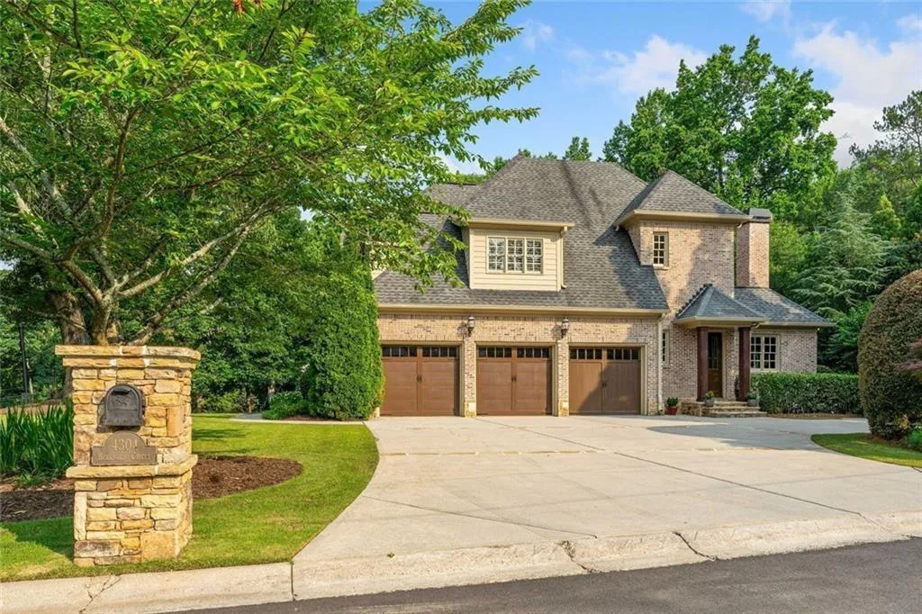 Three car garage with additional parking for 5 vehicles in the driveway.