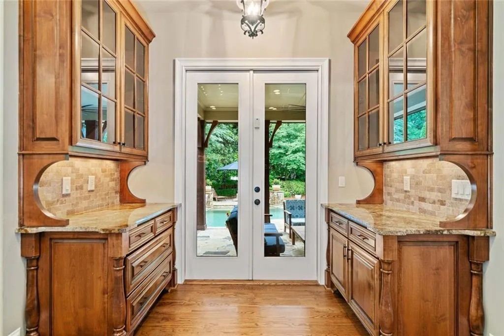 Beautiful glass cabinetry extends the kitchen to the patio.