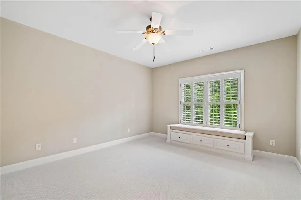 Bedroom #4 is also a generous ensuite with a window seat and built-in storage drawers overlooking the pool area.