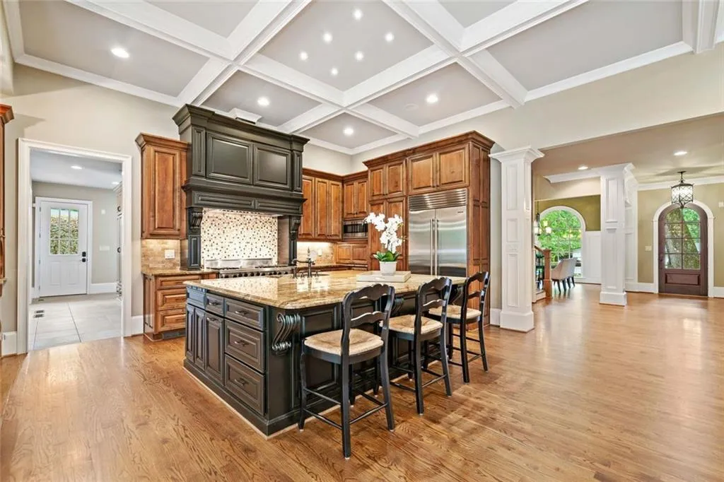 Chef's Kitchen with coffered ceiling and abundant lighting