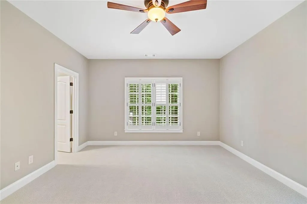 Bedroom #5 is at the end of the hallway and overlooks the side yard.