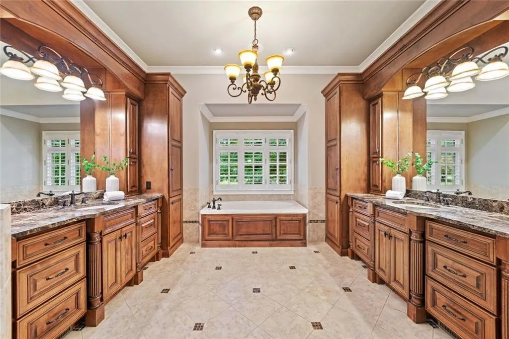 The ensuite bath has dual vanities and a soaking tub.