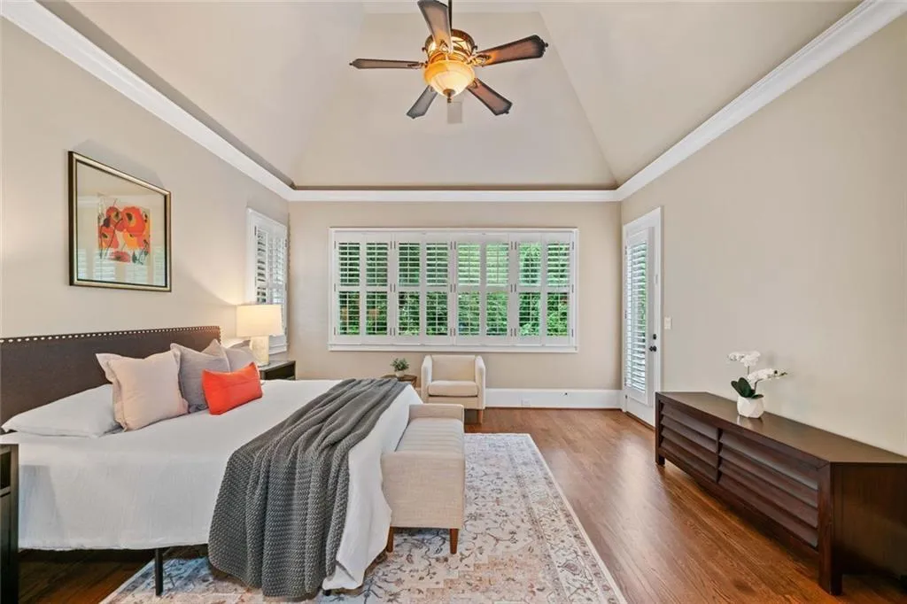 Natural light filters through plantation shutters, and there is direct access to the patio and pool.