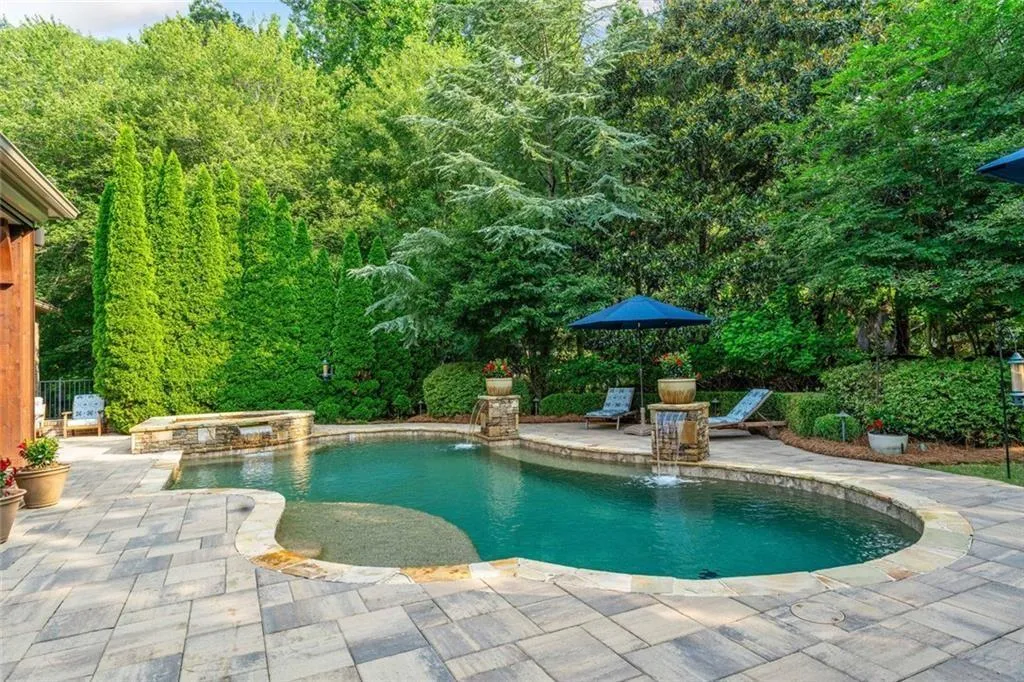 Deodar Cedars, Little Gem Magnolias, White Diamond and Chantilly Lace Hydrangeas and Natchez Crepe Myrtles provide complete privacy around the pool and backyard.