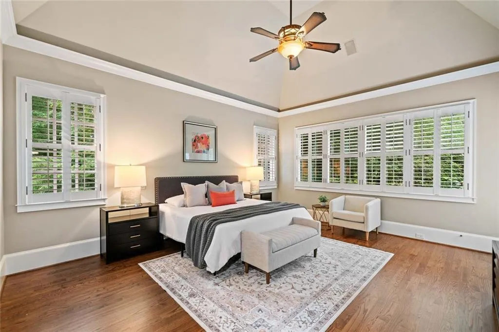 The luxurious primary suite with a cathedral ceiling on the main level offers the perfect private retreat.