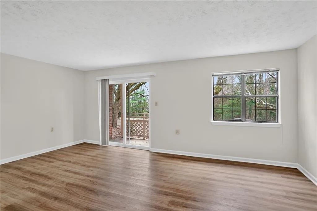 Spare room featuring wood finished floors and a textured ceiling