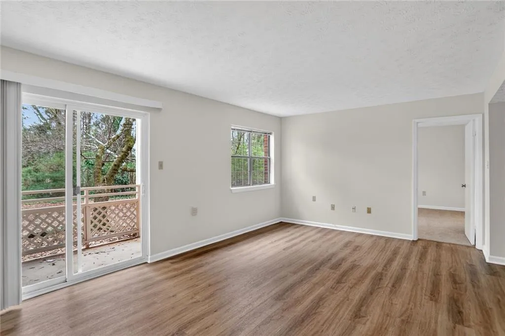 Spare room featuring wood finished floors and a textured ceiling