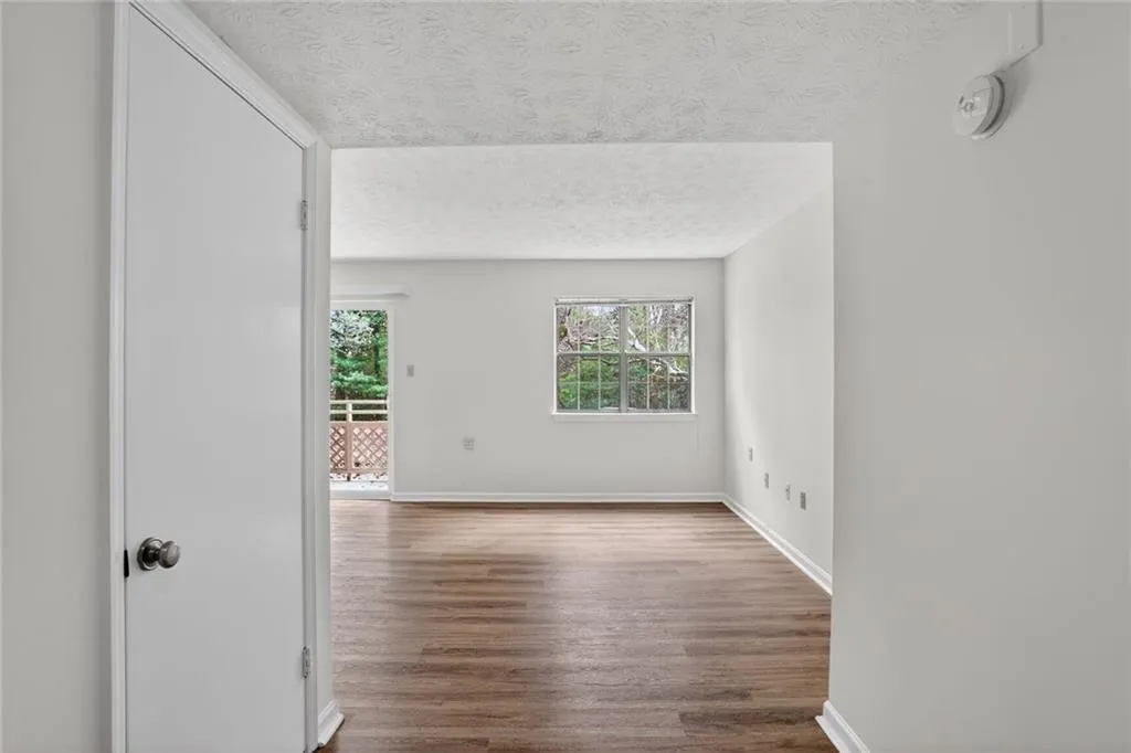 Spare room featuring a textured ceiling and dark wood finished floors