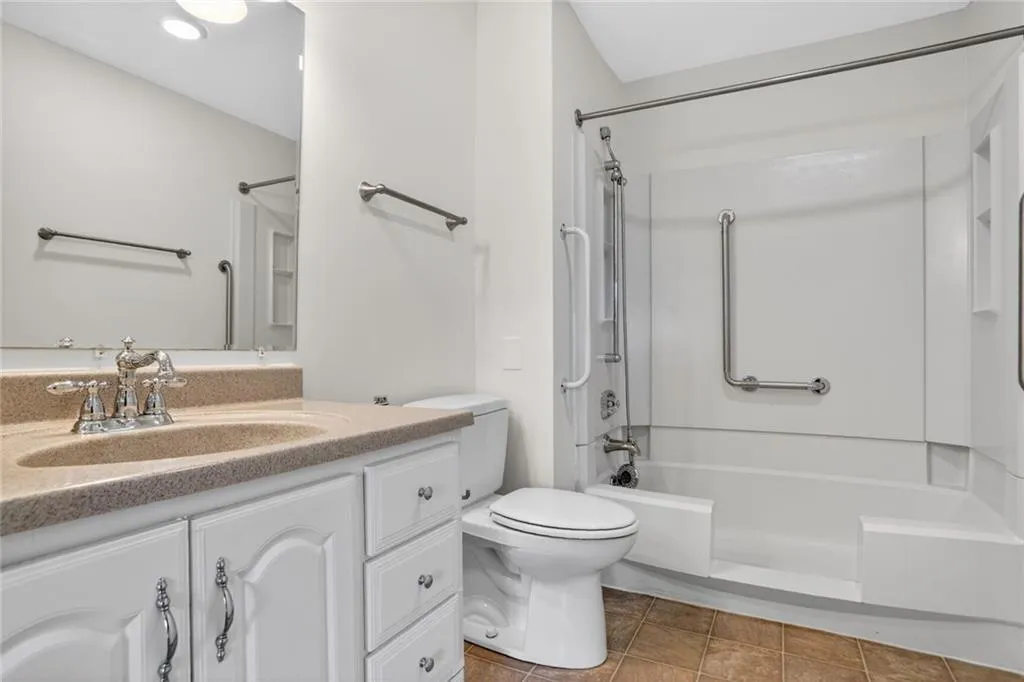 Bathroom with vanity and bathing tub / shower combination