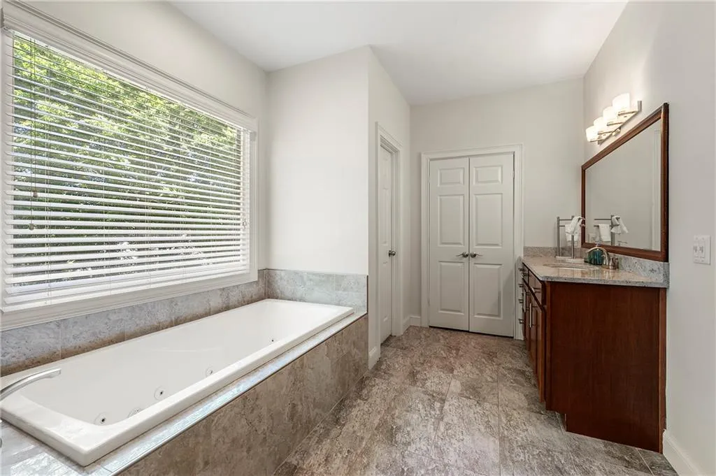 Bathroom featuring vanity and a whirlpool tub