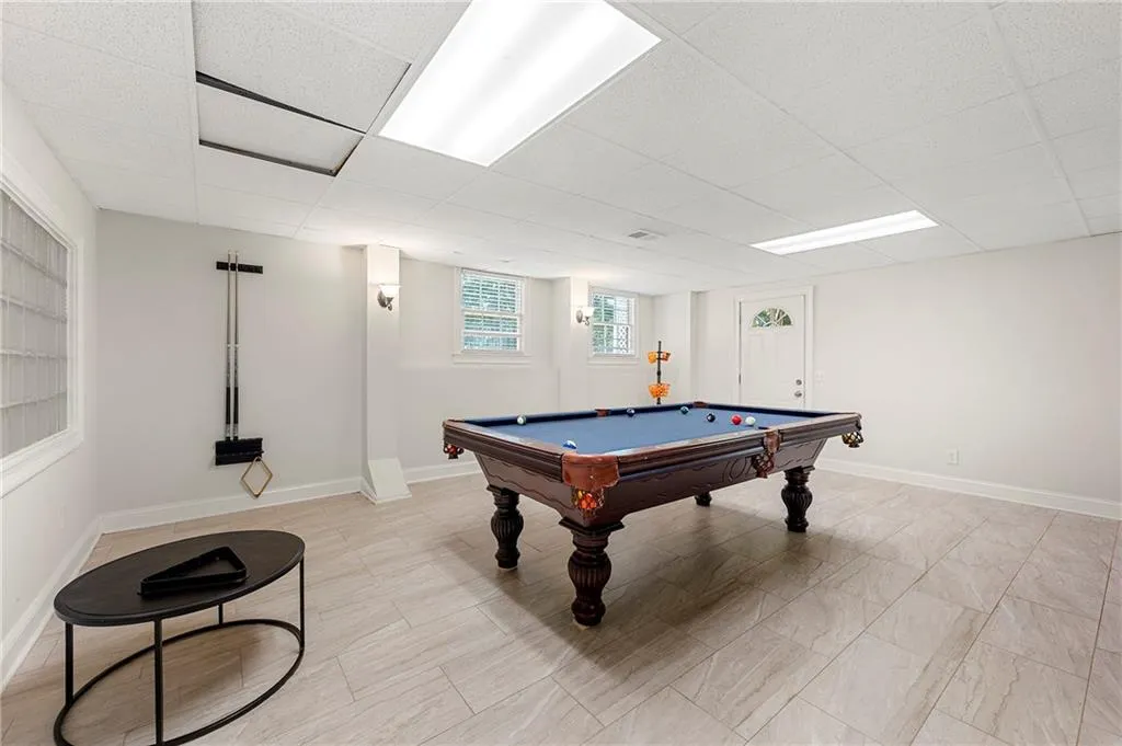 Playroom with billiards, a drop ceiling, and baseboards