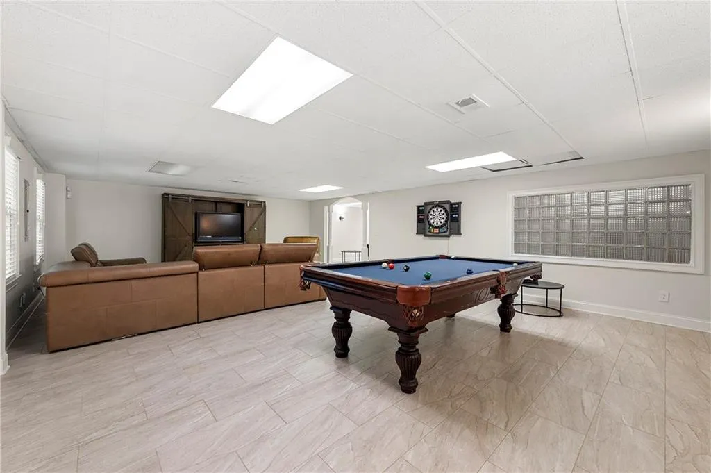 Recreation room featuring billiards table, baseboards, and a drop ceiling