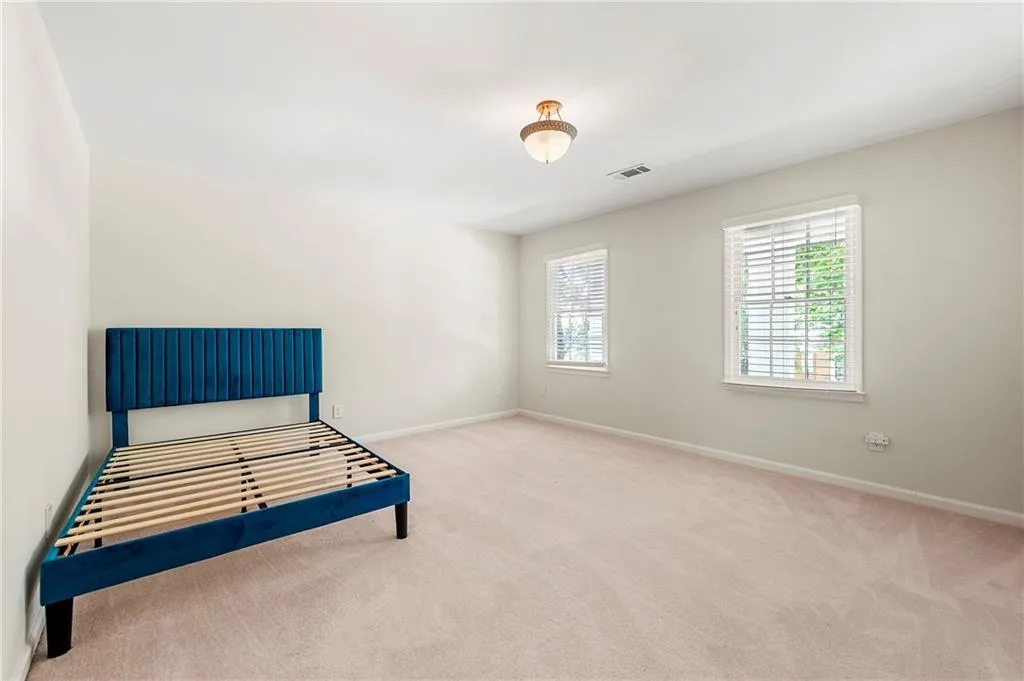 Unfurnished bedroom featuring carpet floors and baseboards