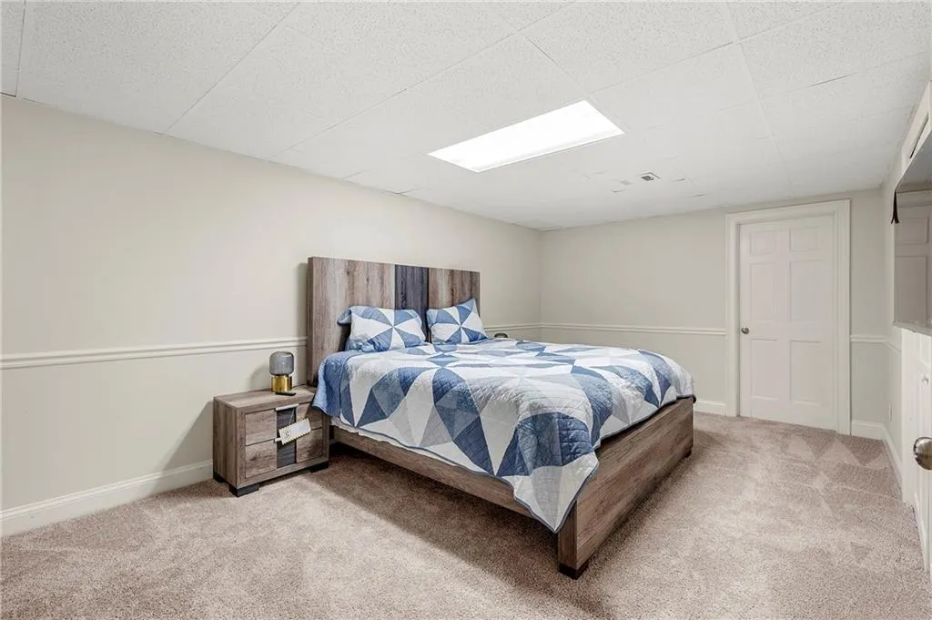 Bedroom with light carpet and baseboards