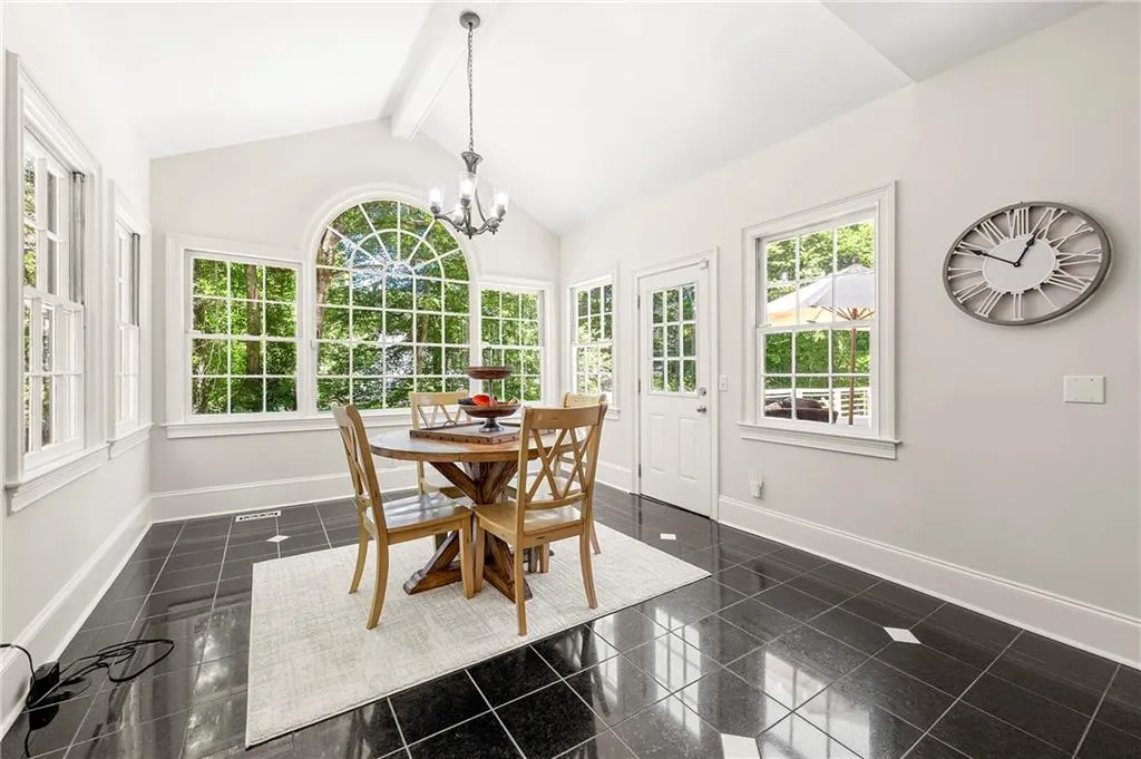 Sunroom / solarium with french doors and a chandelier