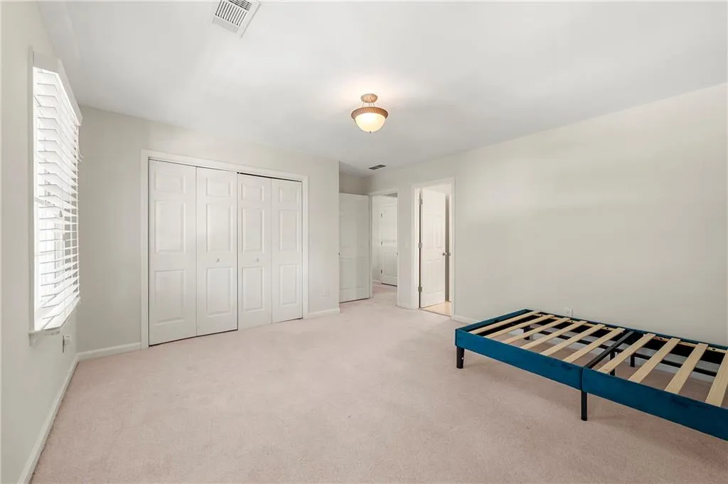 Unfurnished bedroom featuring baseboards, carpet floors, and a closet