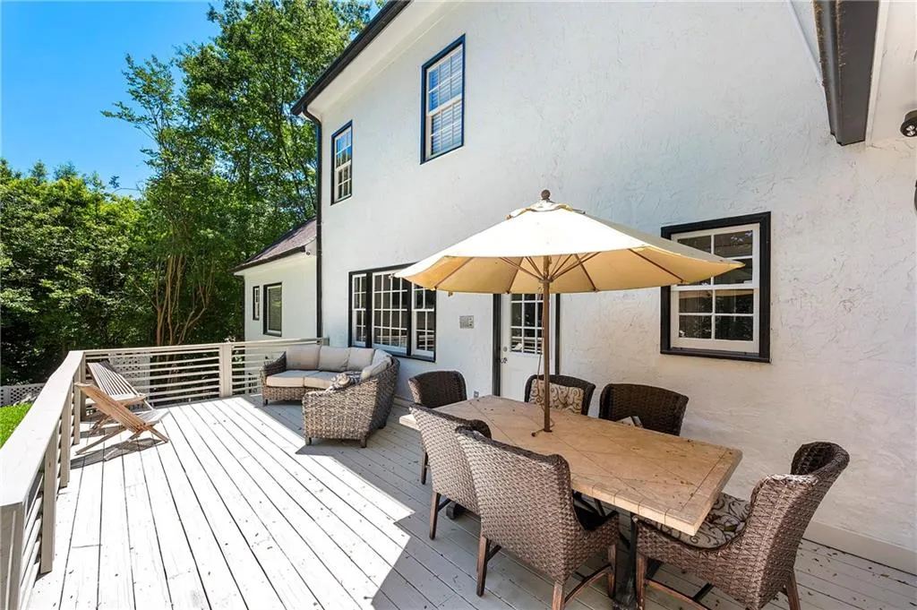 Wooden terrace with an outdoor living space and outdoor dining area