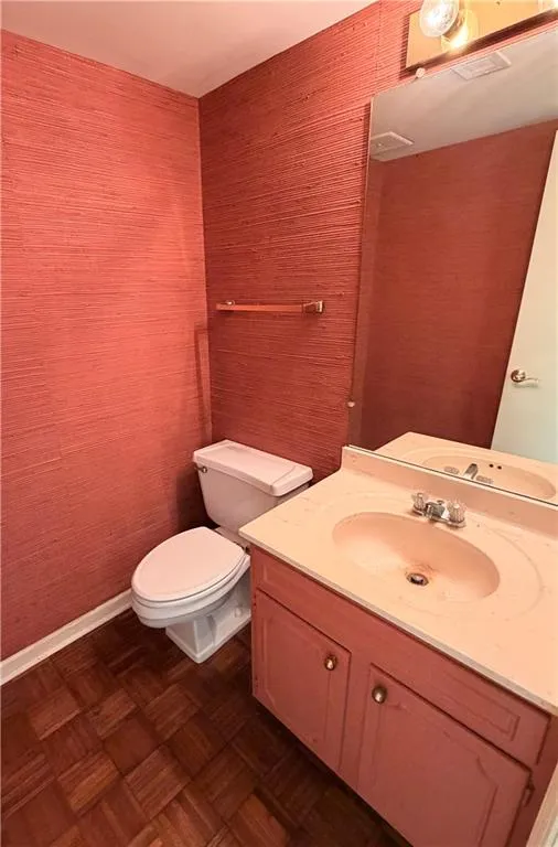 Bathroom featuring vanity and parquet flooring