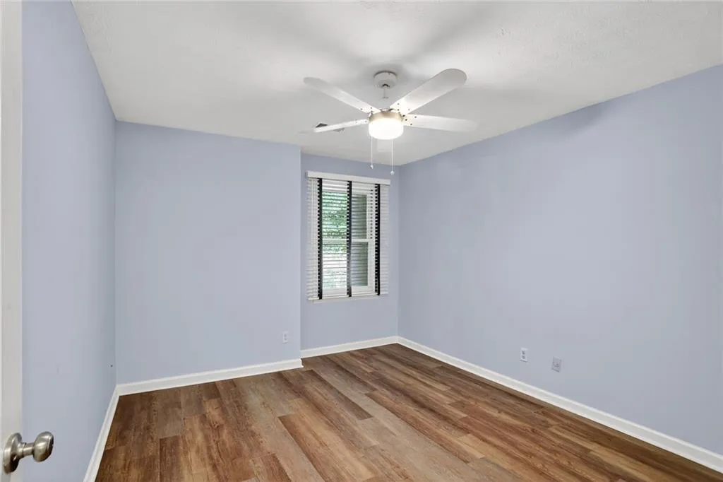 Unfurnished room featuring wood finished floors and a ceiling fan