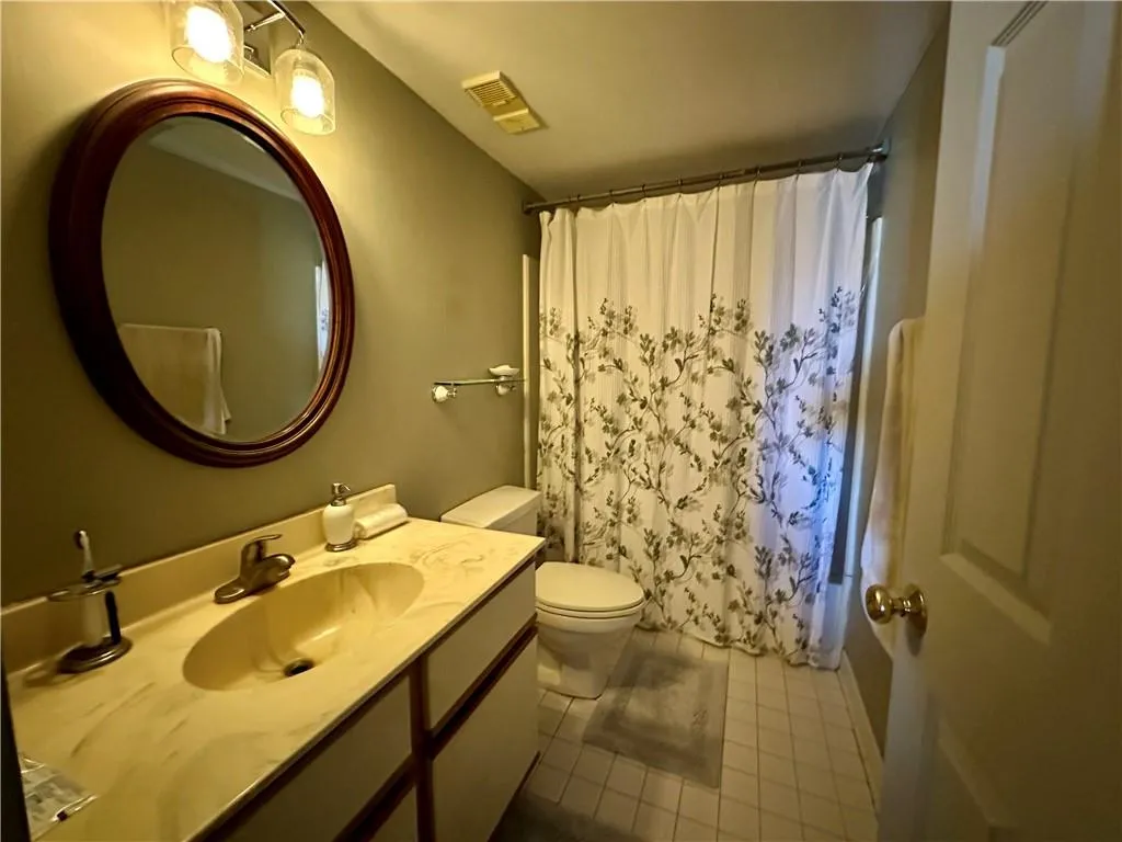 Bathroom with vanity and dark tile patterned flooring