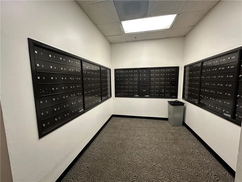 View of home's community with a drop ceiling and mail area