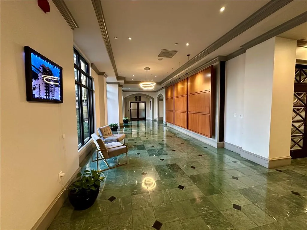 Common area with ornamental molding and recessed lighting