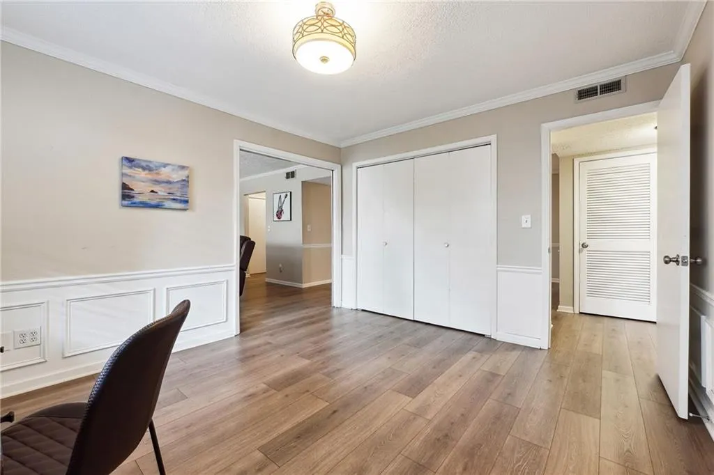 Office with crown molding and light hardwood / wood-style floors
