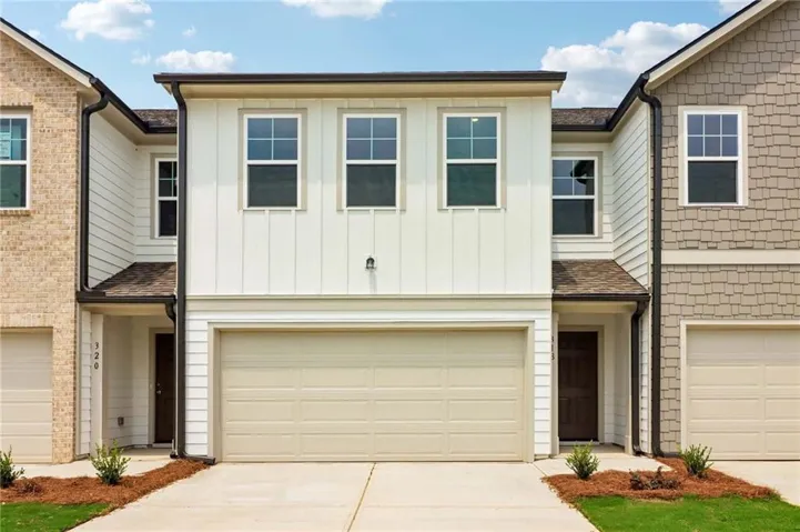 Modern townhome exterior featuring vertical board and batten siding with contrasting horizontal siding
