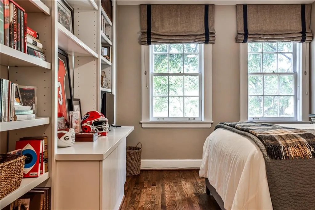 Bedroom featuring dark wood-style flooring and baseboards