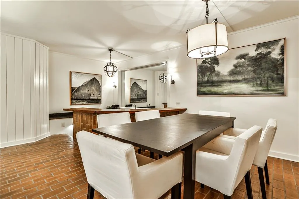 Dining room with ornamental molding and brick floors