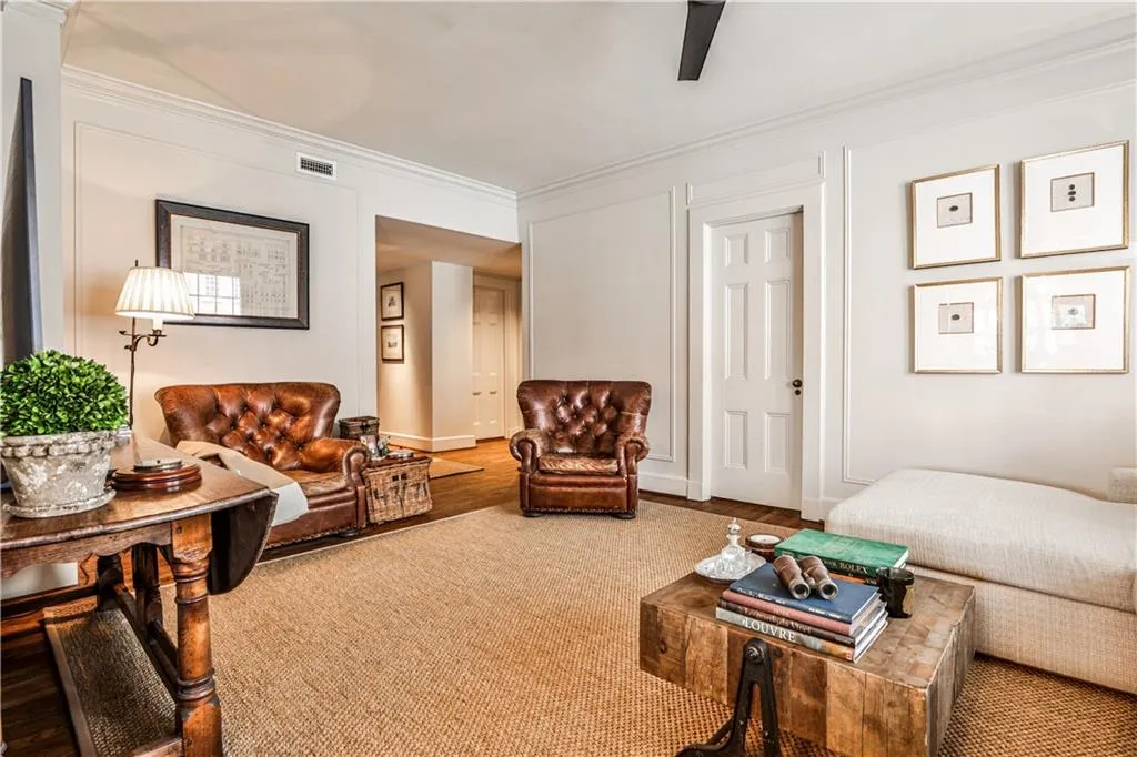 Living room featuring ornamental molding and wood finished floors
