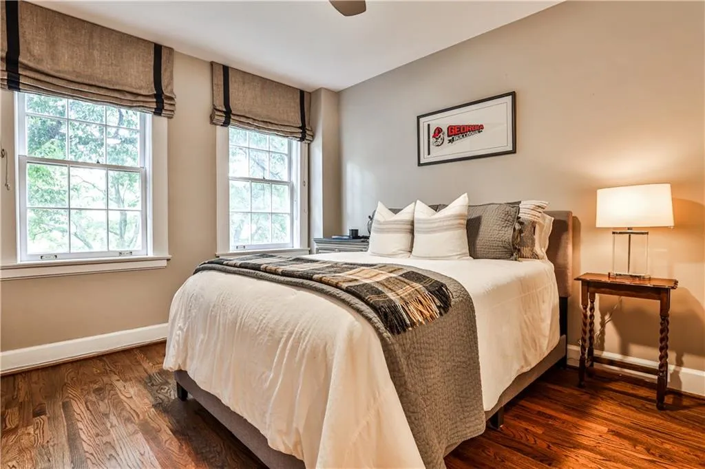 Bedroom with baseboards and dark wood-style flooring