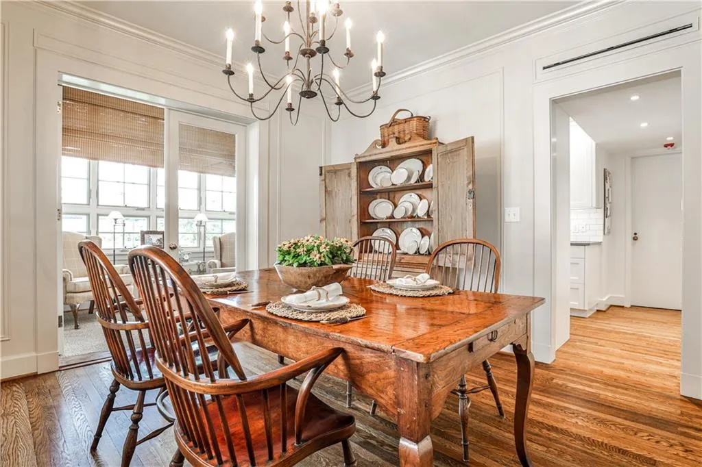 Dining space featuring wood finished floors, ornamental molding, and a chandelier