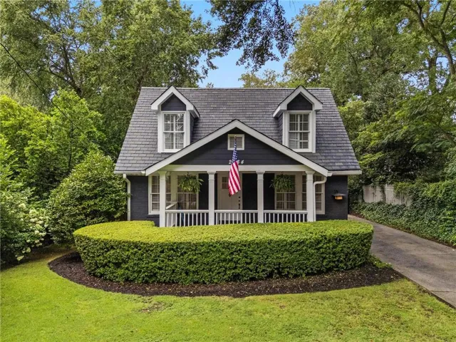 Gabled roofline with dormer windows over a covered porch