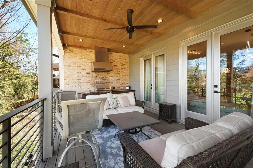Covered exterior porch featuring a wood-panel ceiling, ceiling fan, and recessed lighting