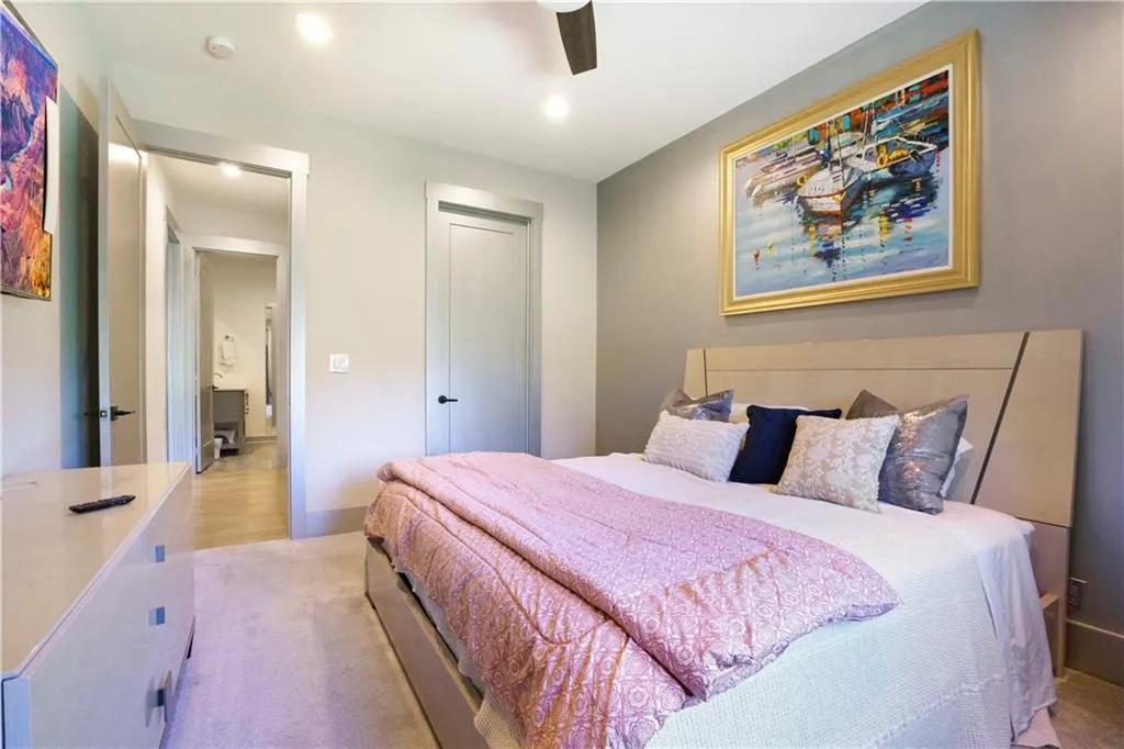 Recessed lighting, wood-finish flooring, ceiling fan, and flat-panel doors with dark hardware