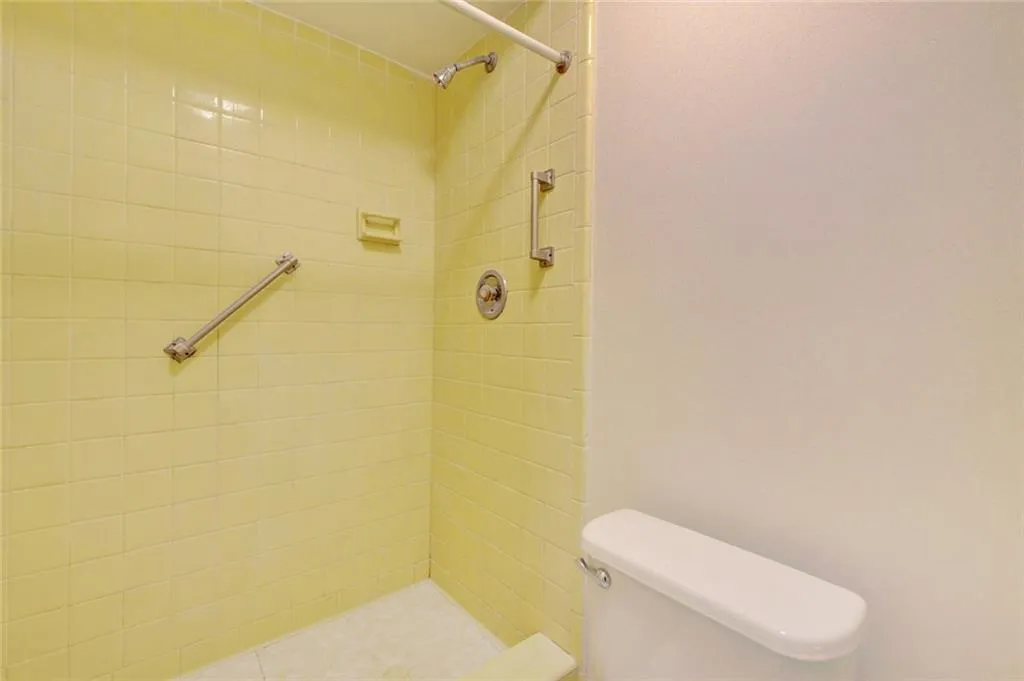 Bathroom with toilet and a tile shower