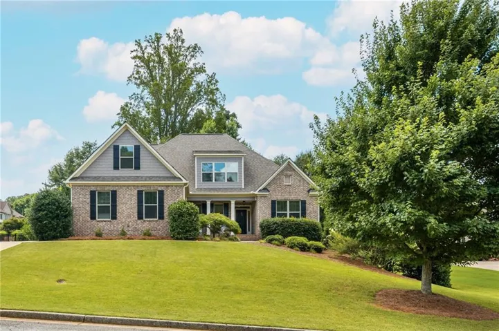 Brick and siding exterior featuring a covered entry porch