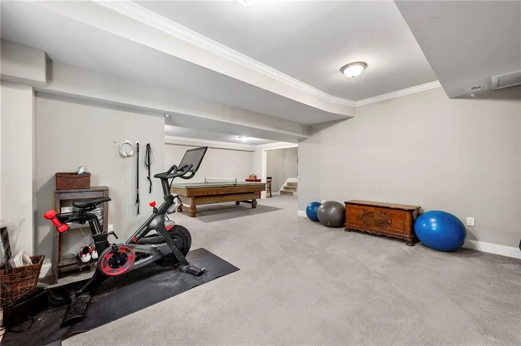 Workout room featuring ornamental molding, baseboards, carpet flooring, and pool table