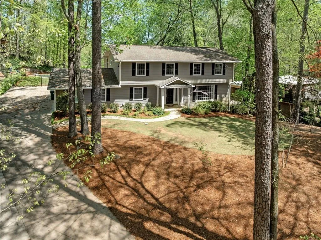 Colonial-style house featuring a front lawn and concrete driveway