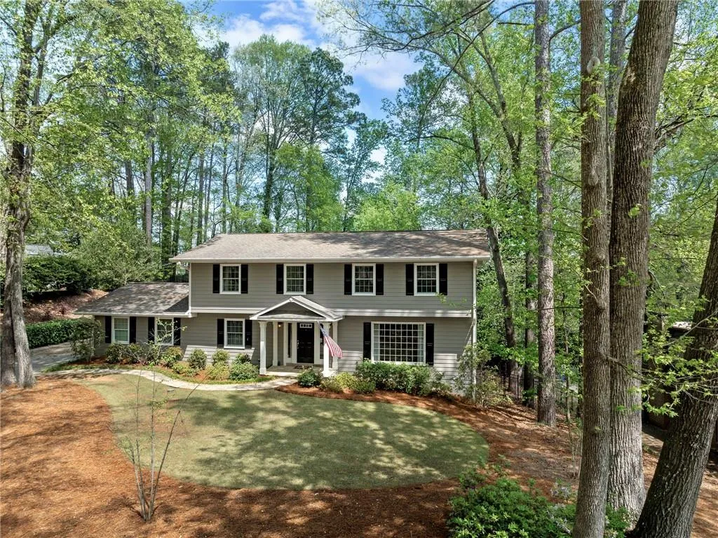 Colonial home with a front yard