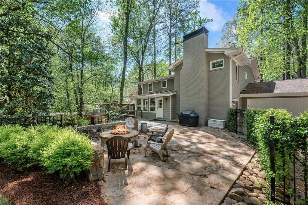 View of patio / terrace featuring a grill, fence, and a fire pit