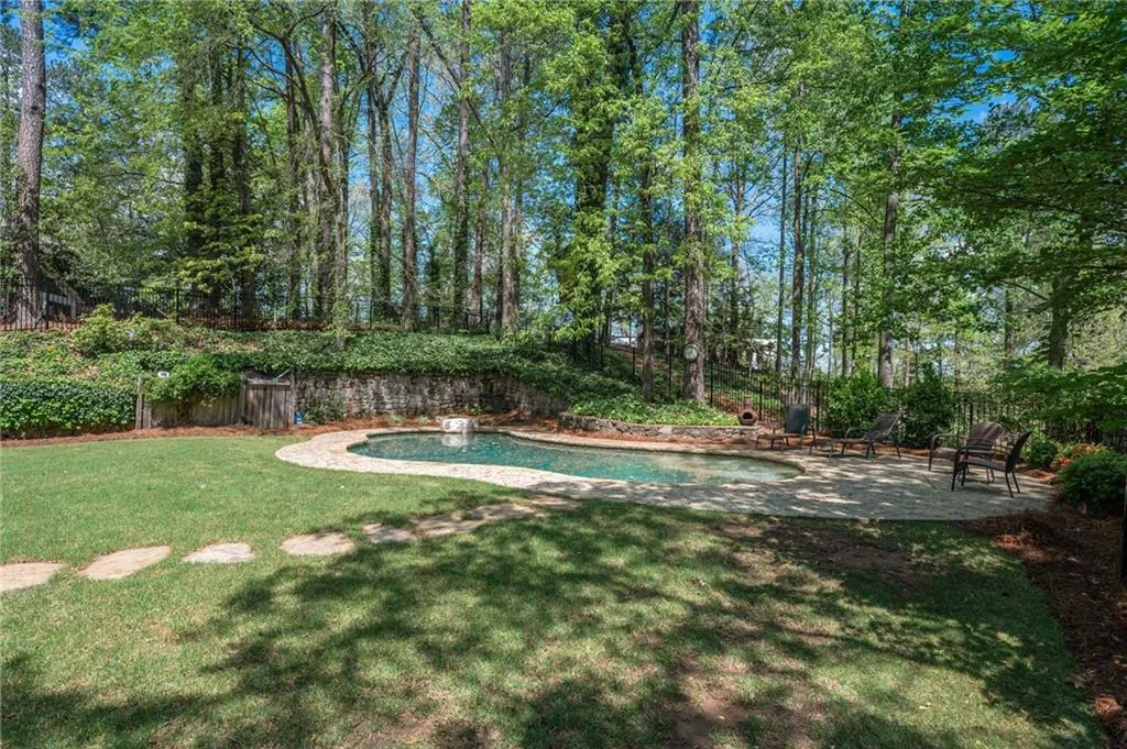 View of yard featuring a patio area, a fenced in pool, and fence