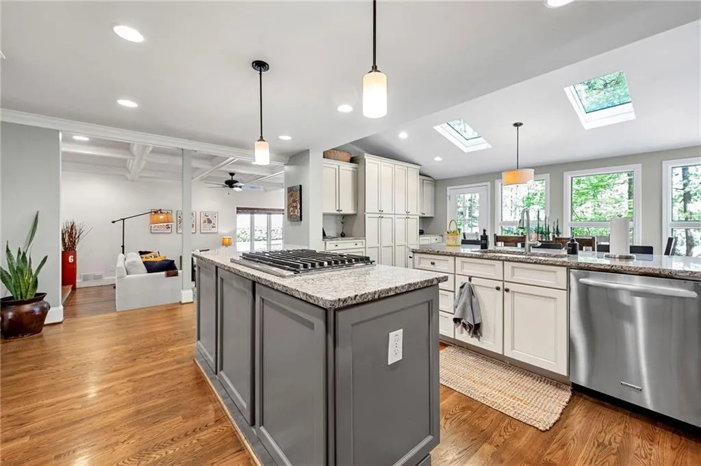 Kitchen featuring a healthy amount of sunlight, a center island, a sink, and appliances with stainless steel finishes
