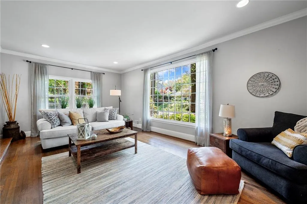 Living area with plenty of natural light, baseboards, and wood finished floors